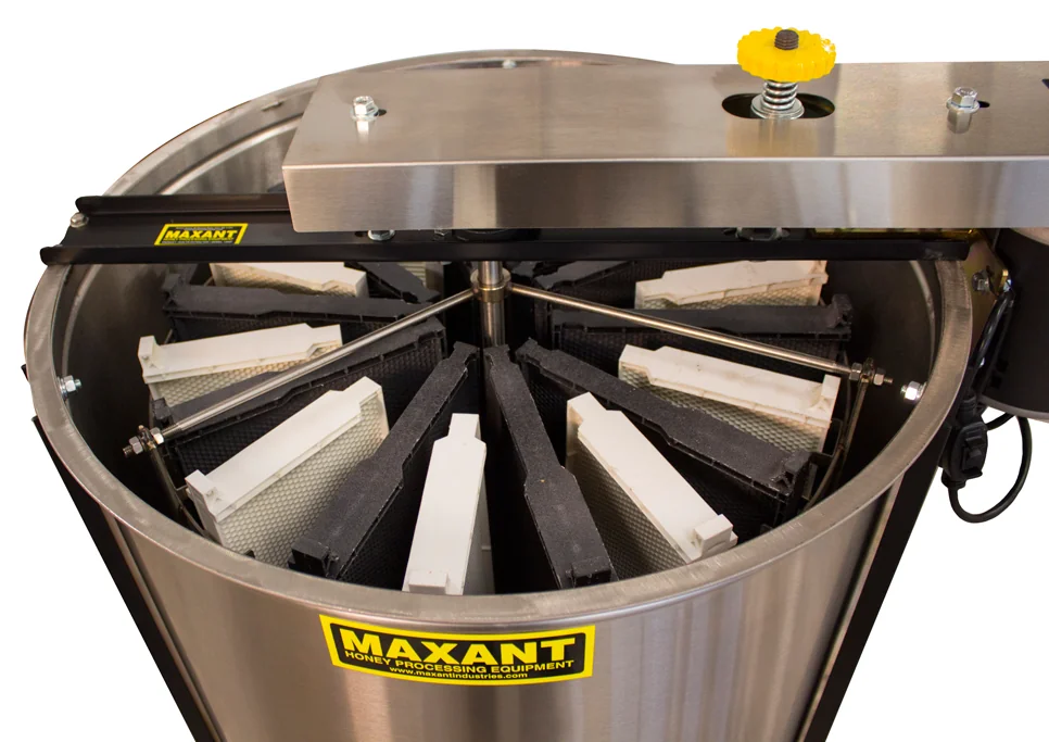 Inside of a stainless steel honey extractor showing the frame baskets