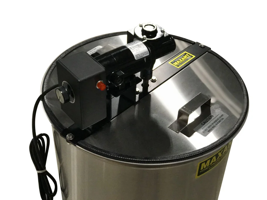 Stainless steel honey extractor with an electric motor on top, seen from above at an angle