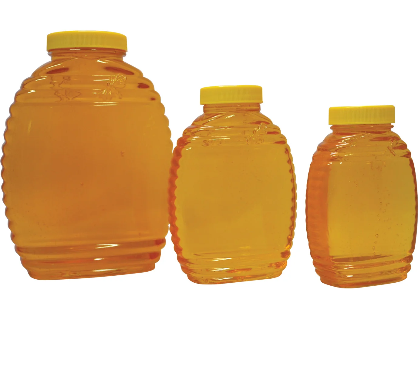 Three glass honey jars in graduated sizes, filled with honey and capped with yellow lids